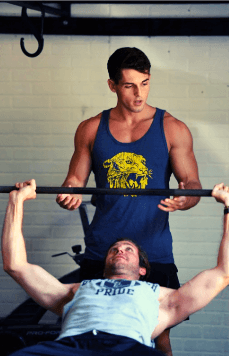Jack McNamara spotting a client on bench press during one-on-one personal training in Austin, TX