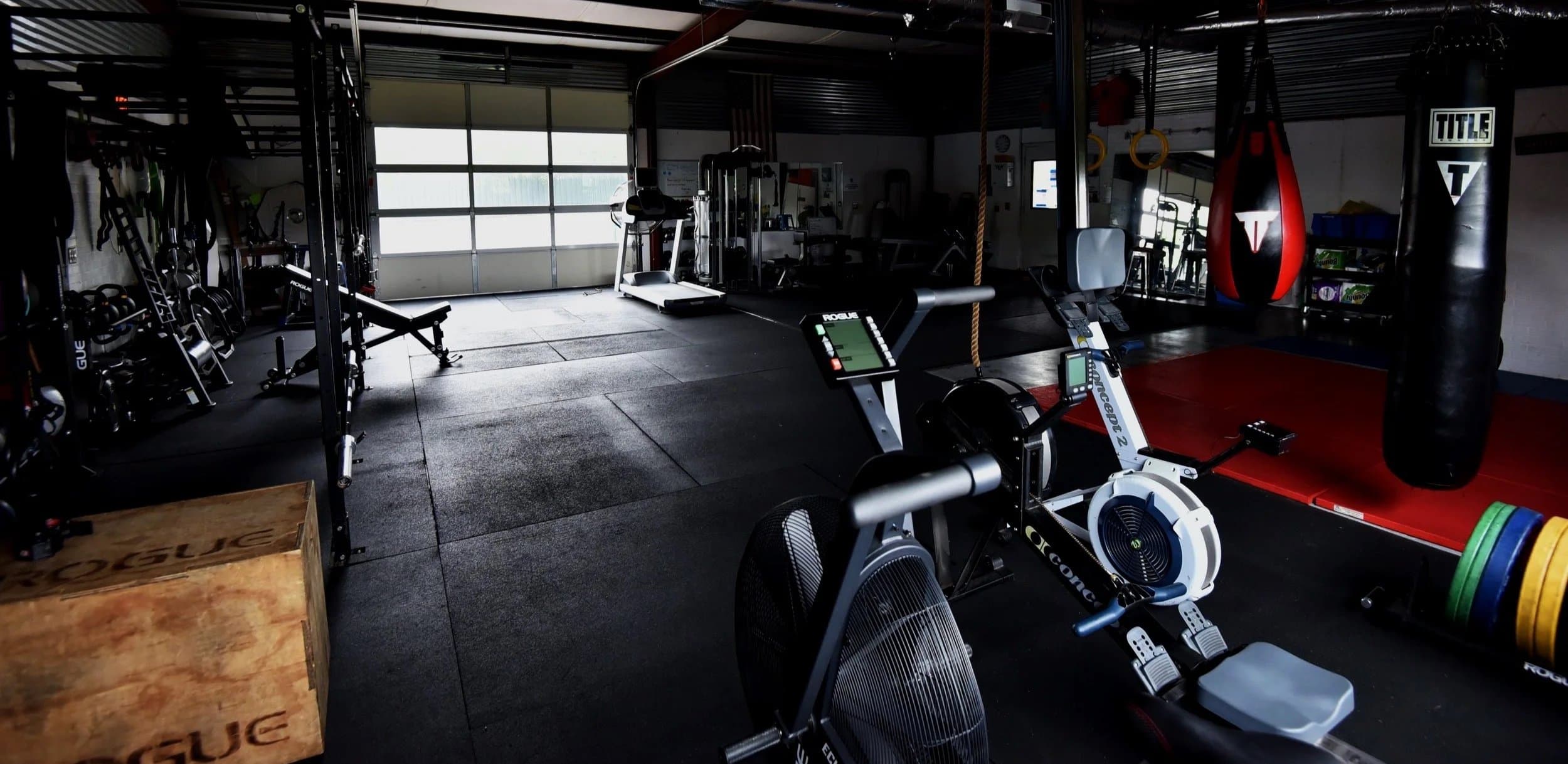 Tiger ATX Training private gym in Southwest Austin showing professional strength racks, dumbbells, and cardio equipment for appointment-only personal training